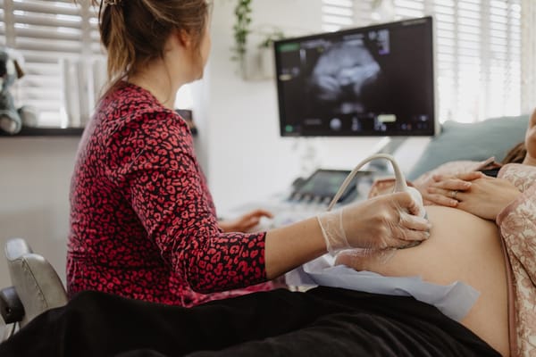 Maria Birch scanning a client at Sneak-A-Peek Ultrasound to illustrate the safety of extra ultrasound scans.